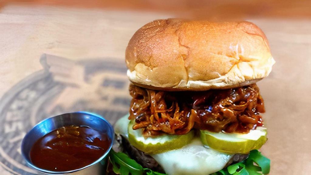 Alpine Pit Burger · This thick 5-ounce patty of certified angus beef is topped with melted alpine swiss cheese, arugula, pickles and BBQ pulled pork. Served with a side of BBQ sauce.