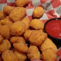 Beer Battered Wisconsin White Cheddar Cheese Curds · Real Wisconsin white cheddar Cheese curds fried golden brown. Served with a side of marinara.