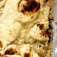 Butter Naan. · Soft flour bread with butter on top.