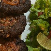 Shami Kabob · Marinated ground lamb grilled in skewers and spices.