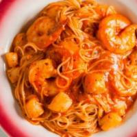 Shrimp, Scallops And An Angel · A bed of angel hair pasta topped with shrimp and scallops in a light tomato sauce.