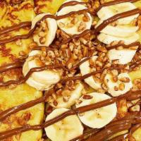 Nutella & Banana Crepes · Stuffed with Nutella and topped with bananas, pecans and chocolate sauce.
