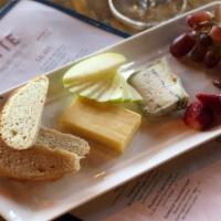 Artisanal Cheese · Three cheeses, house-made jam, fruit, baguette.