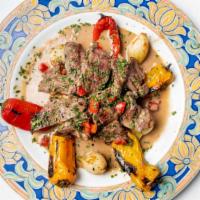 Carne A La Pelayo · Gluten-free. grilled flank steak with garlic potatoes, sautéed vegetables, and blue cheese s...