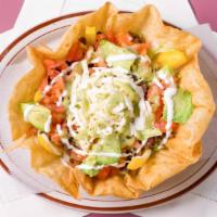 Botana Con Carne · Served with Lettuce, Beans, Cheese, Tomatoes, Onion, Cilantro, Bell peppers, sour cream, Avo...