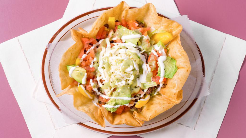 Botana Con Carne · Served with Lettuce, Beans, Cheese, Tomatoes, Onion, Cilantro, Bell peppers, sour cream, Avocado