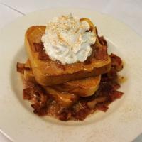 Cinnamon Caramel French Toast · Three slices of french toast served in a bowl with crumbled bacon topped with hot caramel an...