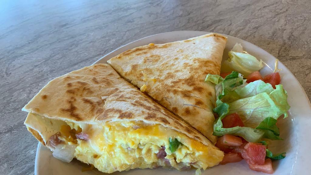 Breakfast Quesadilla · A cheese quesadilla grilled golden brown and stuffed with scrambled eggs, ham, onion and green pepper. With lettuce, tomato and salsa on the side.
Please  subsitutions