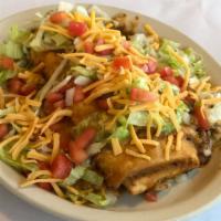 Saucy Burrito · Smothered with chili, shredded lettuce, onions, tomatoes and cheddar cheese.