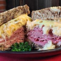 Traditional Corned Beef Reuben · Thinly sliced lean corned beef topped with Schmidt’s sauerkraut, special dressing, und melte...