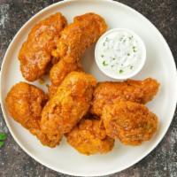 Manic Mango Habanero Wings · Fresh chicken wings, fried until golden brown, and tossed in mango habanero sauce. Served wi...