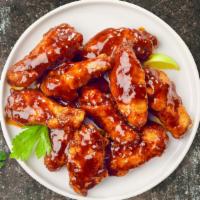 Bbq Bender Wings · Fresh chicken wings, fried until golden brown, and tossed in barbecue sauce. Served with a s...