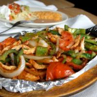 Lunch Fajitas · Beef or chicken cooked with onions, bell peppers and tomatoes. Served with beans, guacamole ...