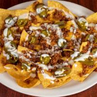 Chori Nachos · A bed of nachos. Topped with cheese sauce, chorizo mexican sausage and jalapeños peppers.