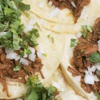 Tacos De Carnitas · Tacos come in orders of 3, topped with diced onion & cilantro on corn tortillas. Served with...