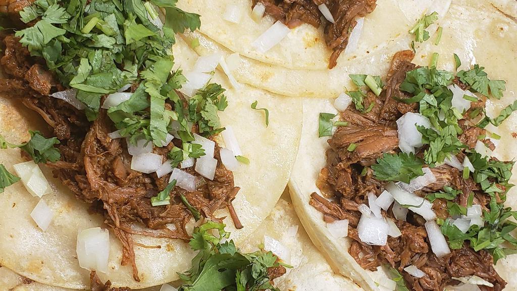 Tacos De Carnitas · Tacos come in orders of 3, topped with diced onion & cilantro on corn tortillas. Served with rice and beans.