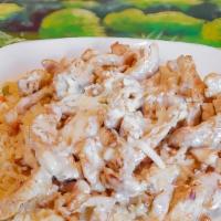 Arroz Con Pollo · Grilled chicken strips served on a bed of rice and topped with cheese sauce.