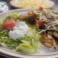 Pollo Fajita Plate · Grilled chicken, bell peppers, onions, tomato, mushrooms topped with melted cheese and our c...