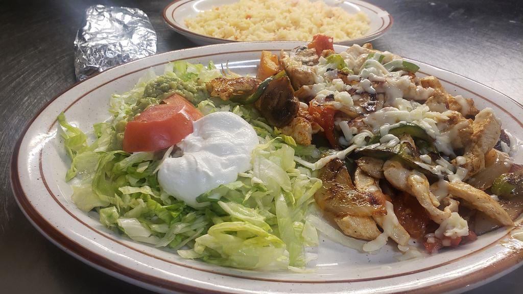 Pollo Fajita Plate · Grilled chicken, bell peppers, onions, tomato, mushrooms topped with melted cheese and our cheese sauce. Served with rice and sour cream salad.