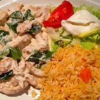 Pollo A La Crema · Grilled chicken breast strips topped with poblano peppers and sour cream special sauce. Serv...