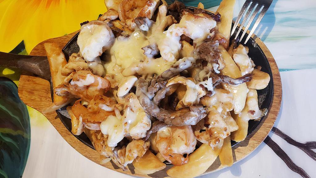 Fajita Gringa · Grilled steak, shrimp, chicken,  over a bed of our crispy steak fries. Topped with mozzarella cheese and our cheese sauce .Served with a side of pickled jalapeño slices.
