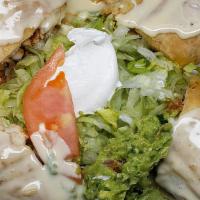 Grilled Chimichanga · Crisp flour tortilla filled with tender grilled chicken or steak with nacho cheese sauce. Se...