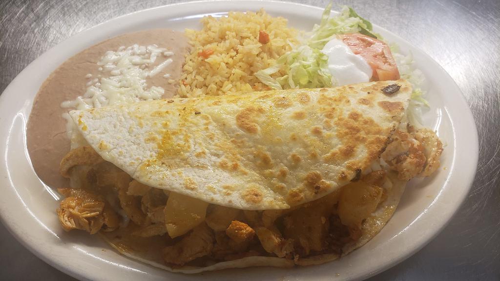 Quesadilla Hawaiian · A unique tropical treat! Filled with grilled chicken, cheese, chorizo, and topped with grilled pineapple. Served with rice, sour cream and salad.