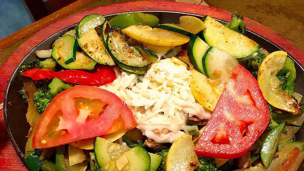 Fajitas Vegetarian · A light combination of fresh zucchini, squash, bell peppers, onions, tomatoes, broccoli, and mushrooms. Served with rice, beans, a side of salad, and tortillas. Served on a sizzling skillet.