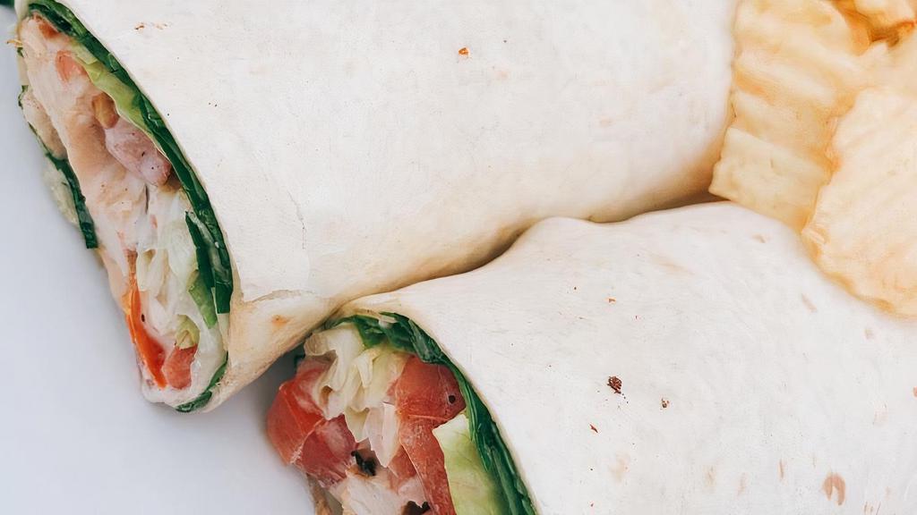 Lemon Tahini Chicken Wrap · Slices of grilled chicken breast with lettuce, tomato, sauteed poblano peppers and onions and our creamy lemon tahini sauce.