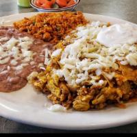 Chilaquiles · Tortilla chips, chorizo & eggs mixed in red sauce with cheese, onion, & sour cream on top