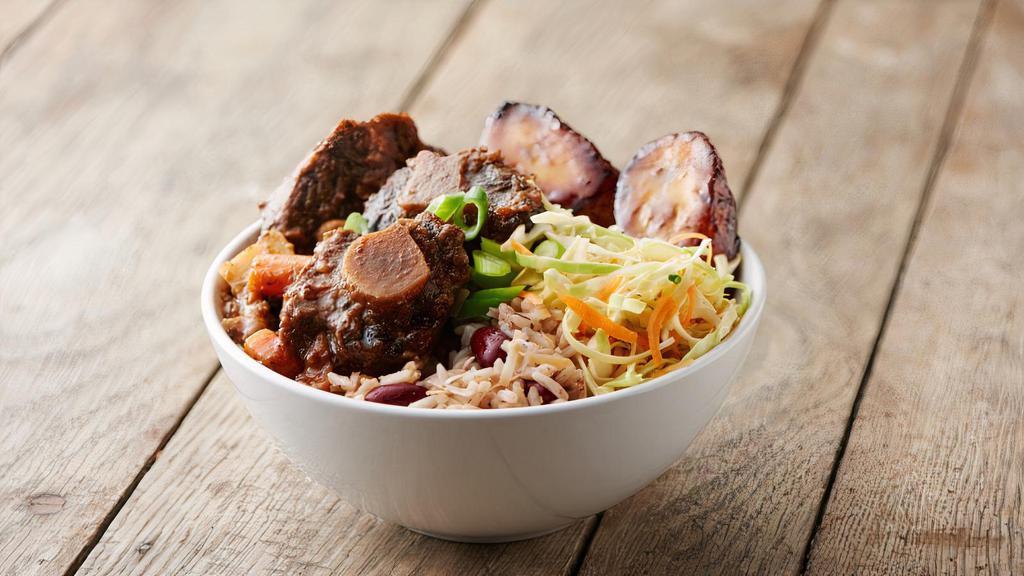 Braised Oxtail · Braised oxtail, served in a bowl only with coconut rice and beans, sweet-fried plantains and island slaw. No sauce included.