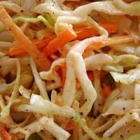 Island Slaw · Shredded green cabbage, red cabbage, carrot and scallion in a sweet citrus vinaigrette.