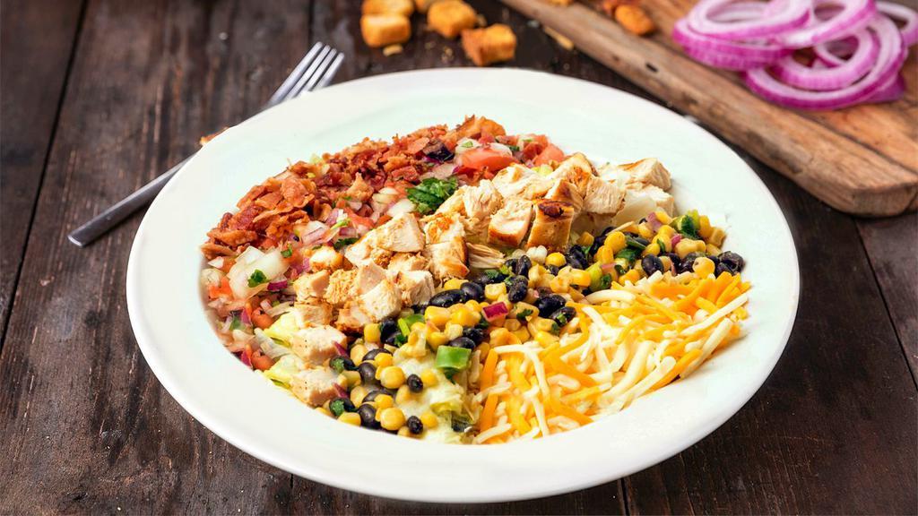 Southwestern Cobb Salad · Enjoy our hickory grilled chicken, homemade corn & black bean salsa, shredded cheese, bacon and homemade pico de gallo on a bed of mixed greens.