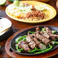 Steak Fajitas* · Tender, marinated steak served on a sizzling skillet with freshly grilled onions and peppers...