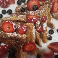 Very Berry French Toast · Topped with strawberries, blueberries and whipped cream.