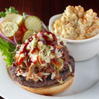 Backyard Burger · ½ Pound Black Angus burger topped with pulled pork, homemade coleslaw, BBQ sauce, lettuce, t...