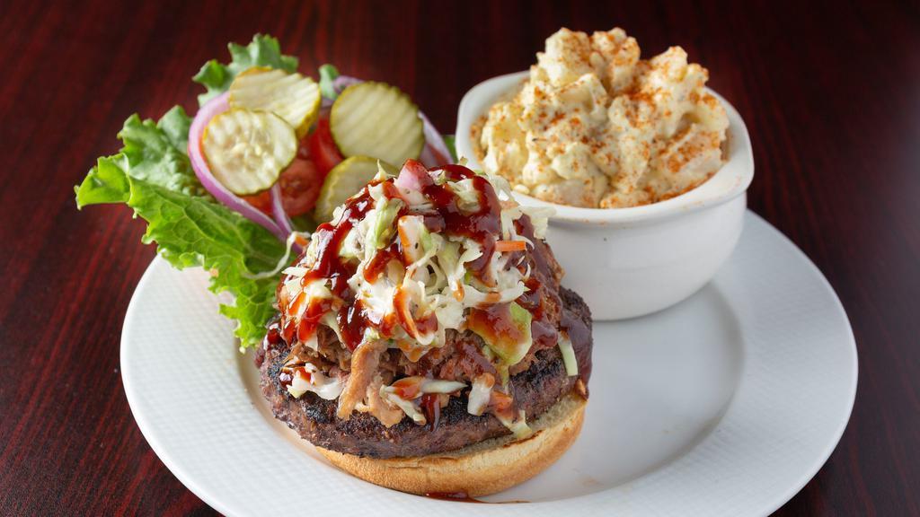 Backyard Burger · ½ Pound Black Angus burger topped with pulled pork, homemade coleslaw, BBQ sauce, lettuce, tomato, onion, and pickle