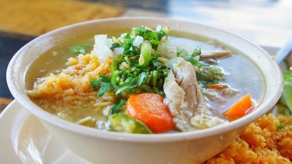 Caldo De Pollo · Hearty soup made with chicken, cabbage, carrots, and zuchini.. On the side: chopped onions, chopped jalapenos, cilantro, and choice of tortillas.