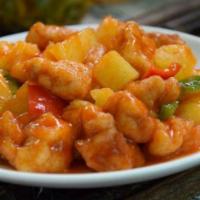 Sweet & Sour Pork · Breaded pork deep fried with onion green peppers pineapple and carrots .sauce on the side.