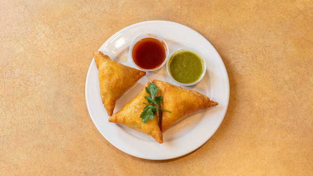Vegetable Samosa (2 Pcs) · Crisp turnovers filled with mildly spiced potatoes and peas.