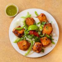 Chicken Tikka · Marinated chicken cubes cooked in tandoor with herbs and spices.