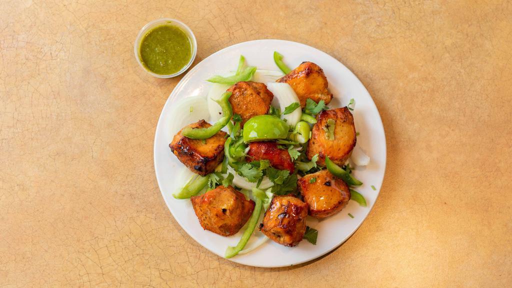 Chicken Tikka · Marinated chicken cubes cooked in tandoor with herbs and spices.