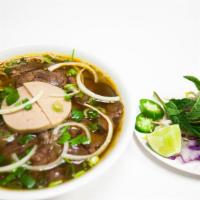 Beef Vermicelli In Spicy Soup (Bun Bo Hue) · Central Vietnamese lemongrass beef-broth soup. Served with round rice noodle, sliced beef sh...