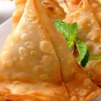 Vegetable Samosa · Crispy pastry stuffed with potatoes, peas and seasoned with spices.