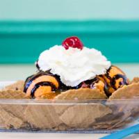 Ice Cream Nacho · One scoop ice cream with waffles chips, three topping with whipped cream, and cherry.