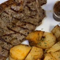 10 Oz Strip Steak Baked Pot & Salad & Rolls · 