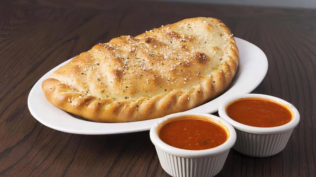 Cheese Calzone · Mozzarella cheese wrapped with butter-brushed dough, sprinkled with parmesan and oregano, then baked to perfection. Served with a side of marinara sauce. Your choice of toppings is available.