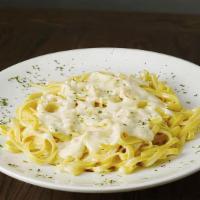 Fettuccine Alfredo · Flat noodles and cream sauce. Served with garlic bread and grated cheese.