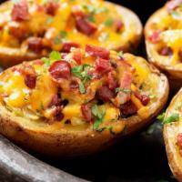 Potato Skins · Crispy potato skins filled with bacon, Cheddar cheese and sour cream.