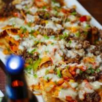 Nachos · tortilla chips topped with seasoned ground beef or chicken,  tomato ,green pepper ,onion, me...